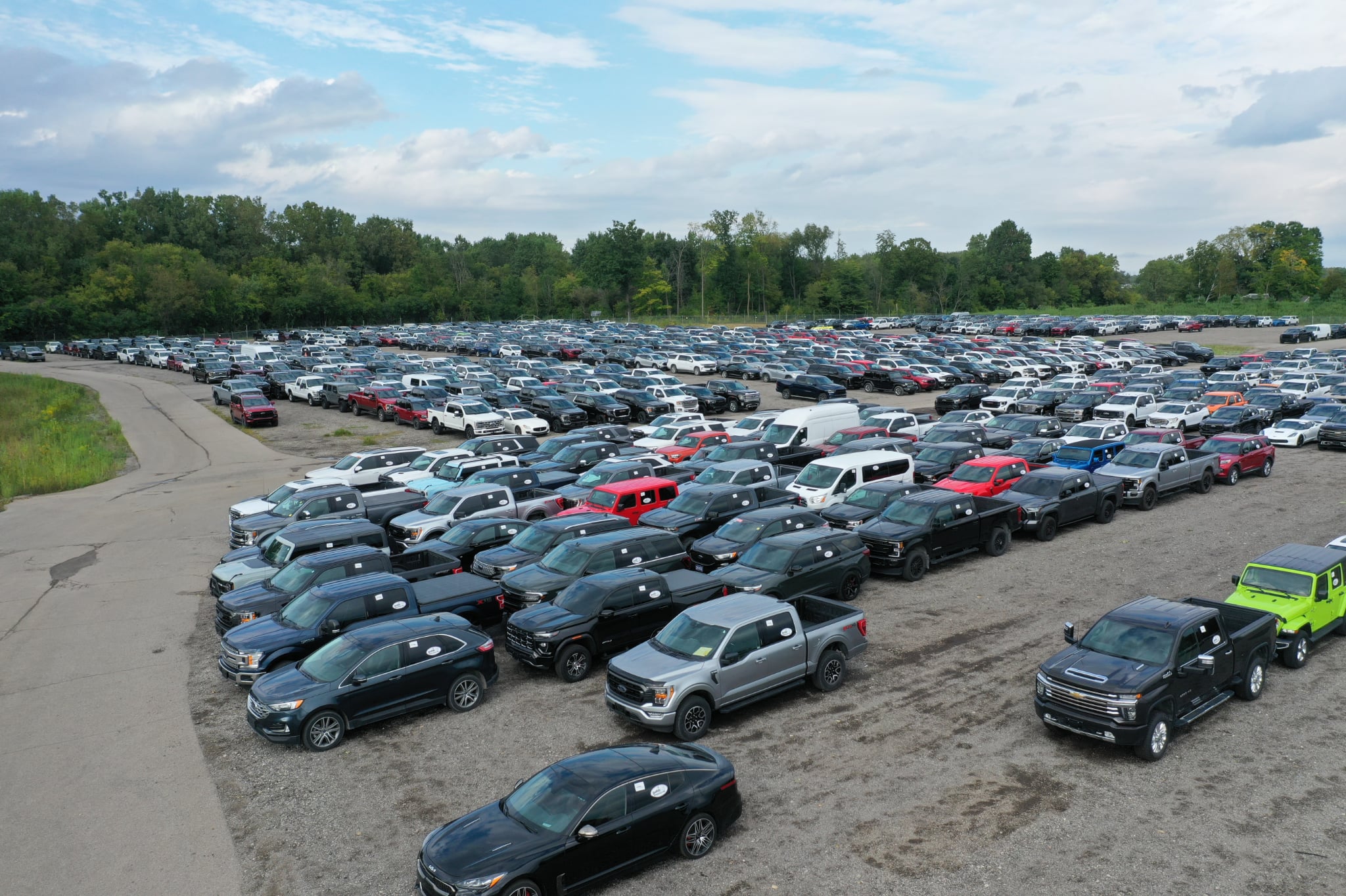 Aerial view of hundreds of wholesale vehicles staged in the lot