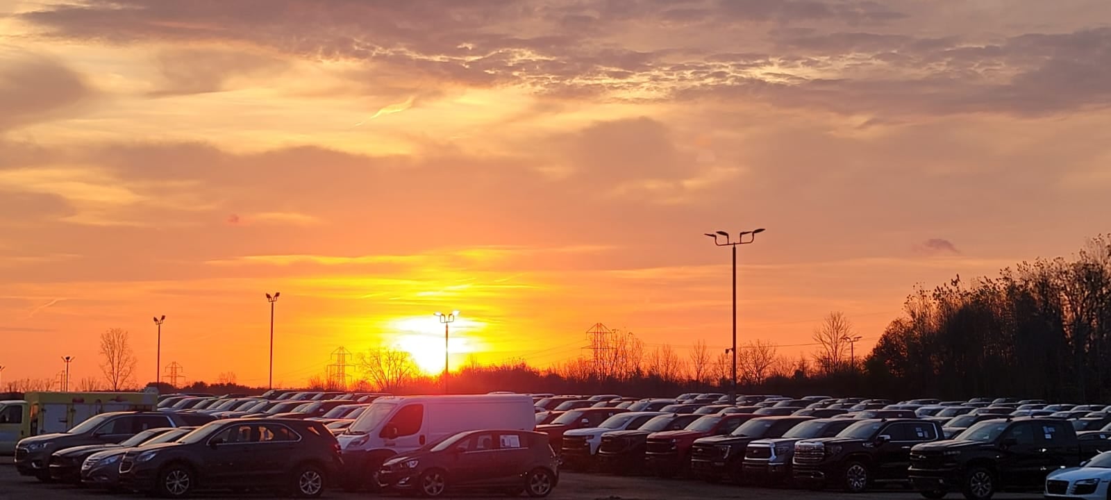 Sunset over rows of wholesale inventory staged for the lanes