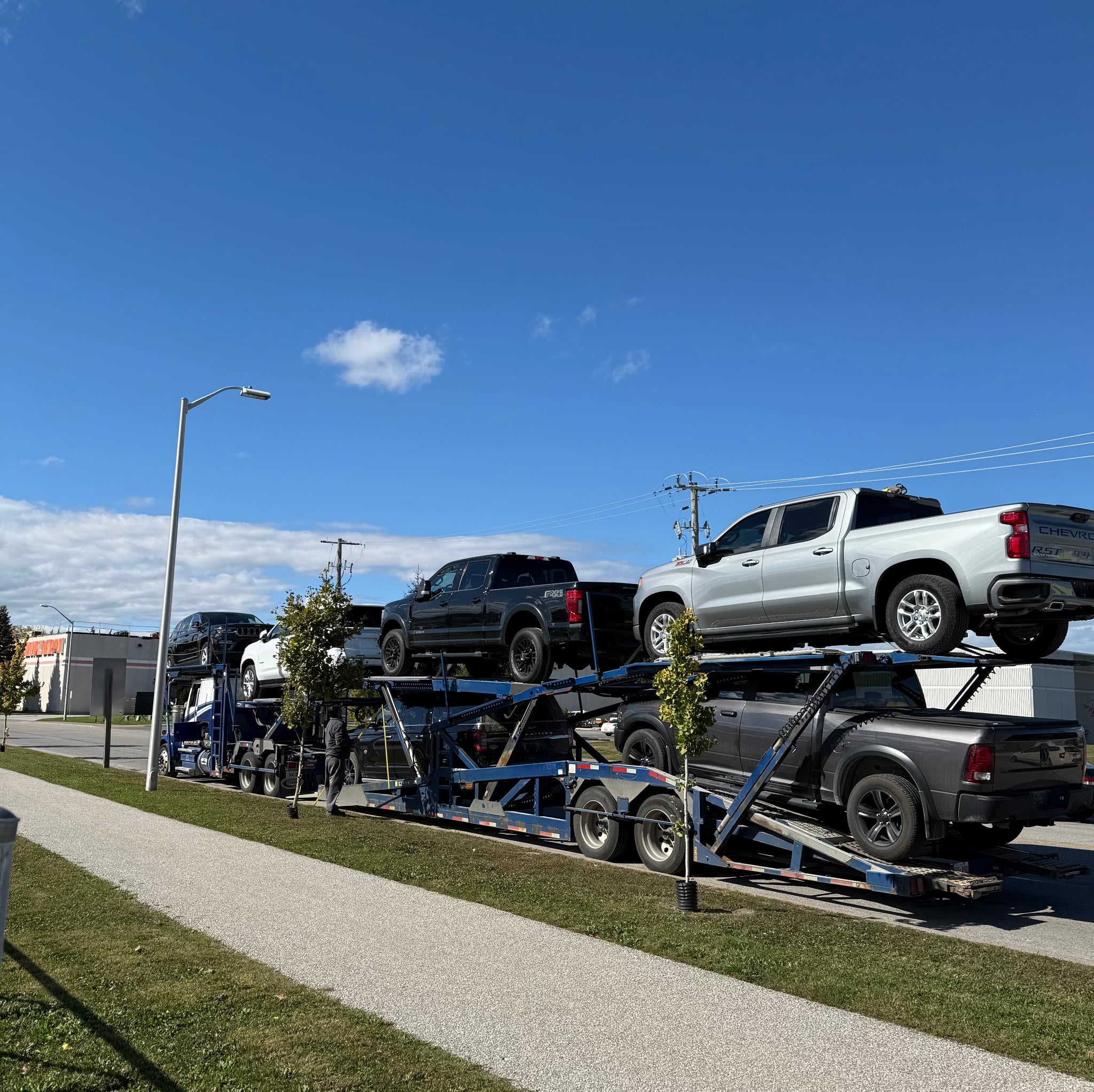 Car carrier loaded with pickup trucks ready for delivery