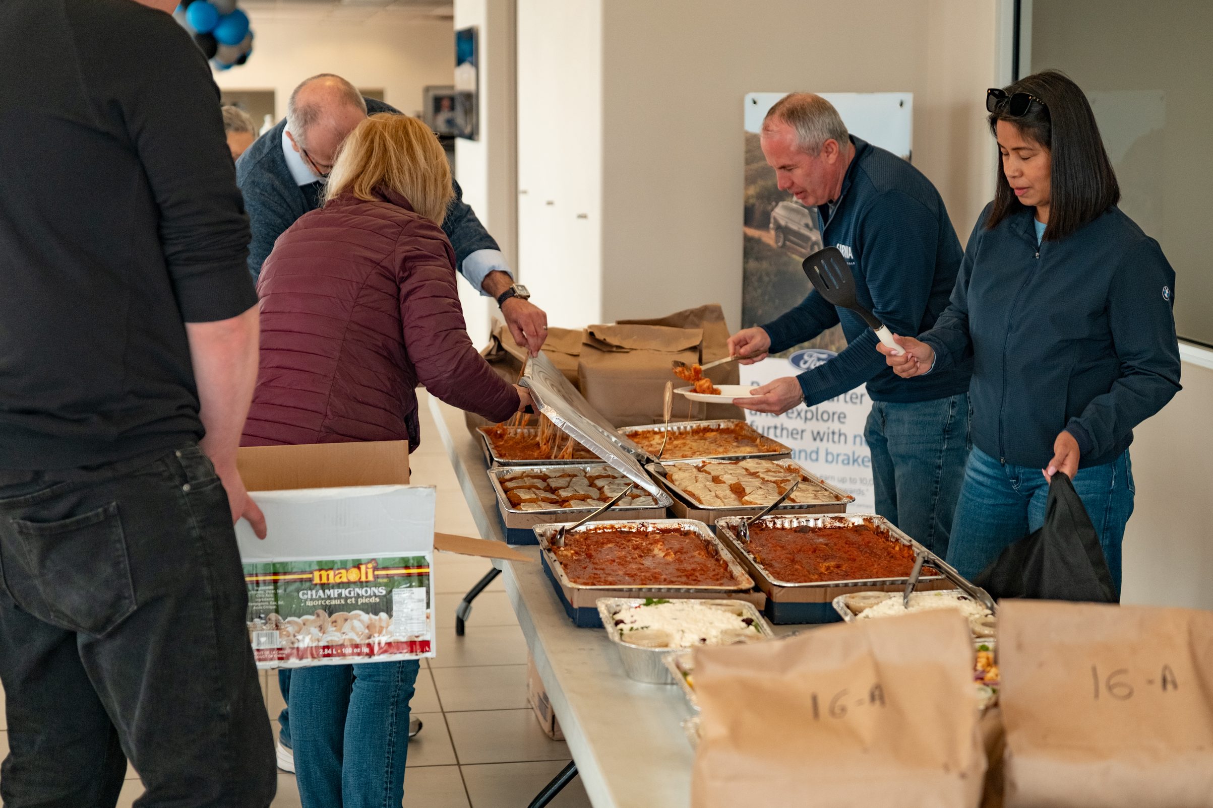 Team members serving food at a company event